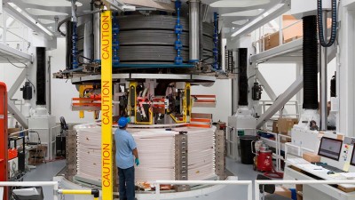 A technician works on one of the electromagnets that will power ITER  (General Atomics)