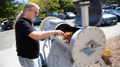 Zap Energy CTO and co-founder Brian Nelson works the FuZE Grill during a cookout at the company’s new headquarters building in Everett, WA.