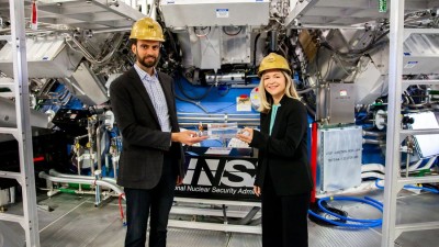 Dr. Andrea Kritcher and Dr. Alex Zylstra of the Lawrence Livermore National Laboratory stand in the National Ignition Facility’s target bay.