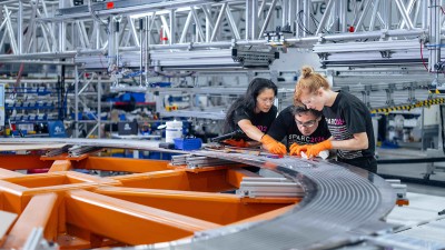 CFS technicians carefully inspect a radial plate for SPARC, a fusion pilot power plant
