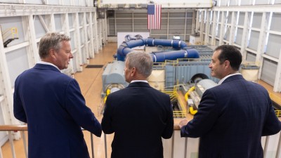 From left, Type One Energy CEO Christofer Mowry, Tennessee Gov. Bill Lee, and TVA president and CEO Don Moul stand in the old turbine room of the Bull Run fossil plant.