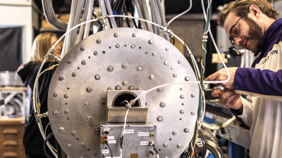 Graduate student Jared Smythe (right) and undergraduate Kirsten Alderson (left) work on the ZaP-HD fusion energy development device in the UW's Flow Z-Pinch Lab.
