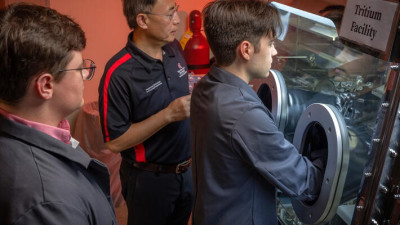 Professor and Director of Nuclear Engineering Raymond Cao (middle) with graduate students in the Nuclear Reactor Lab